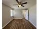 Bright bedroom with modern ceiling fan and stylish wood-look floors, creating a comfortable and airy space at 118 Dove Lndg, Social Circle, GA 30025