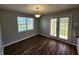 Bright dining area featuring elegant French doors and stylish wood-look floors, perfect for gatherings at 118 Dove Lndg, Social Circle, GA 30025