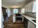 Modern kitchen showcasing stainless steel appliances, granite countertops, and an open view to the dining area at 118 Dove Lndg, Social Circle, GA 30025