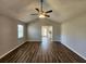 Inviting living room with a modern ceiling fan and attractive wood-look floors, bathed in natural light at 118 Dove Lndg, Social Circle, GA 30025