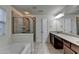 Bathroom featuring a glass shower, bathtub, and dual vanity sink at 13030 Dartmore Ave, Alpharetta, GA 30005