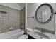 Cozy bathroom with a tub and a granite sink at 13030 Dartmore Ave, Alpharetta, GA 30005