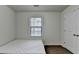 This bedroom includes a window for natural light, dark wood floors, and a closet with a door at 13030 Dartmore Ave, Alpharetta, GA 30005