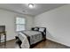 This bedroom features a window for natural light, dark wood floors, and a desk at 13030 Dartmore Ave, Alpharetta, GA 30005