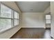 Bright room featuring two large windows and hardwood flooring at 13030 Dartmore Ave, Alpharetta, GA 30005