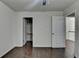 A bedroom features neutral walls, wood-look floors, a ceiling fan, and an adjacent walk-in closet at 13030 Dartmore Ave, Alpharetta, GA 30005