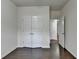 Cozy bedroom with hardwood floors, white walls and multiple doors at 13030 Dartmore Ave, Alpharetta, GA 30005