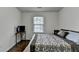 This bedroom includes a window for natural light, dark wood floors, and a desk at 13030 Dartmore Ave, Alpharetta, GA 30005