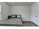 Cozy bedroom with wood floors features a comfortable bed, side table, and a convenient closet at 13030 Dartmore Ave, Alpharetta, GA 30005