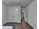 This bedroom has dark wood floors, a double door closet, and white walls at 13030 Dartmore Ave, Alpharetta, GA 30005