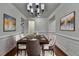 Elegant dining room featuring a stylish chandelier and decorative artwork at 13030 Dartmore Ave, Alpharetta, GA 30005