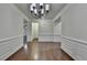 Dining room with hardwood floors, wainscoting, and neutral paint at 13030 Dartmore Ave, Alpharetta, GA 30005