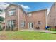 Brick home exterior with a walk-out patio and ample backyard space at 13030 Dartmore Ave, Alpharetta, GA 30005