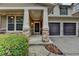 Charming front porch with stone accents and a well-manicured lawn at 13030 Dartmore Ave, Alpharetta, GA 30005