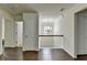 This hallway includes a staircase, a chandelier, and doors that lead to other rooms at 13030 Dartmore Ave, Alpharetta, GA 30005
