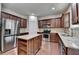 Bright kitchen with stainless steel appliances, ample cabinet space, and central granite island at 13030 Dartmore Ave, Alpharetta, GA 30005