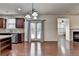 Open kitchen seamlessly connects to the dining area with views of living area and back yard at 13030 Dartmore Ave, Alpharetta, GA 30005