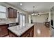 Kitchen with center island and stainless appliances overlooks the dining and living areas at 13030 Dartmore Ave, Alpharetta, GA 30005