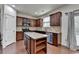 Well-lit kitchen features stainless steel appliances, a central island, and ample cabinet space at 13030 Dartmore Ave, Alpharetta, GA 30005