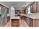 Beautiful kitchen with wood floors features stainless steel appliances and a granite topped island at 13030 Dartmore Ave, Alpharetta, GA 30005