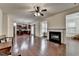 Spacious living area with fireplace, hardwood floors, and open-concept design with kitchen at 13030 Dartmore Ave, Alpharetta, GA 30005