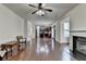 Open-concept floor plan showcases a fireplace, hardwood floors, and connects living spaces at 13030 Dartmore Ave, Alpharetta, GA 30005