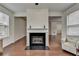 Neutral living room with fireplace and large windows bringing in an abundance of natural light at 13030 Dartmore Ave, Alpharetta, GA 30005
