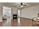 Open-concept living room features hardwood floors and a fireplace, perfect for entertaining at 13030 Dartmore Ave, Alpharetta, GA 30005