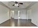 Bright bedroom featuring hardwood floors and multiple entryways at 13030 Dartmore Ave, Alpharetta, GA 30005