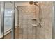 This bathroom features a tiled shower stall with a wall-mounted shower head and glass door at 13030 Dartmore Ave, Alpharetta, GA 30005