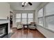 Cozy sun room with ample natural light streaming through large windows with a fireplace feature at 13030 Dartmore Ave, Alpharetta, GA 30005