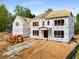 Two-story home under construction, featuring framed windows and modern architectural design at 1445 West Wesley Ne Rd, Atlanta, GA 30327