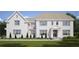 Charming two-story home boasts a white brick exterior, well-manicured lawn, and elegant architectural details at 1445 West Wesley Ne Rd, Atlanta, GA 30327