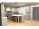 A spacious kitchen with a large center island, stainless steel appliances and light gray cabinetry at 1445 West Wesley Ne Rd, Atlanta, GA 30327