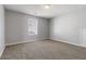 Spacious bedroom with neutral walls, carpeted floors, and ample natural light from a window at 4811 Westgate Blvd, Atlanta, GA 30349