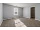 Bedroom featuring neutral paint and carpeting, with view of large window at 4811 Westgate Blvd, Atlanta, GA 30349