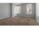 Bright bedroom with neutral walls, carpeted floors and two windows for natural light at 4811 Westgate Blvd, Atlanta, GA 30349