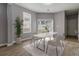 Bright dining room featuring a modern table, stylish chairs, and a sliding glass door at 4811 Westgate Blvd, Atlanta, GA 30349