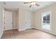Well-lit bedroom showcasing wood floors, white trim, and a view of the pool from the window at 510 Price Rd, Carrollton, GA 30116