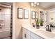 Bright bathroom featuring double sinks, floral shower curtain, and modern fixtures at 5109 Hillside Haven Dr, Powder Springs, GA 30127