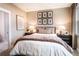 Cozy bedroom featuring a large window, feather wall art, and soft bedding at 5109 Hillside Haven Dr, Powder Springs, GA 30127