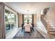 Elegant dining room with stylish furniture, a modern chandelier, and access to a covered outdoor space at 5109 Hillside Haven Dr, Powder Springs, GA 30127