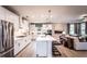 Bright kitchen with white cabinetry, stainless steel appliances, granite countertops, and seamless access to the living area at 5109 Hillside Haven Dr, Powder Springs, GA 30127