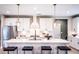Contemporary kitchen boasting white cabinets, granite counters, a stainless steel refrigerator, and bar seating at 5109 Hillside Haven Dr, Powder Springs, GA 30127