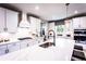 Bright kitchen featuring white cabinets, quartz countertops, stainless steel appliances, and pendant lighting at 5109 Hillside Haven Dr, Powder Springs, GA 30127