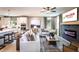 Stylish living room with fireplace, plush seating, a flat-screen TV, and abundant natural light from large windows at 5109 Hillside Haven Dr, Powder Springs, GA 30127