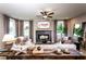 Sophisticated living room featuring a cozy fireplace, comfortable seating, and ample natural light at 5109 Hillside Haven Dr, Powder Springs, GA 30127