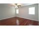 Bedroom with hardwood floors, ceiling fan, and windows with natural light at 5415 Keithwood Dr, Cumming, GA 30040