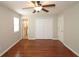 Bedroom featuring hardwood floors, a ceiling fan, closet, and ensuite bathroom entrance at 5415 Keithwood Dr, Cumming, GA 30040