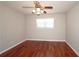 This bedroom offers lots of natural light from the window and hardwood floors at 5415 Keithwood Dr, Cumming, GA 30040